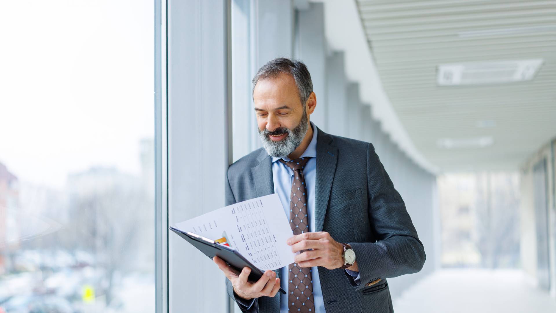 Man in suit reading papers